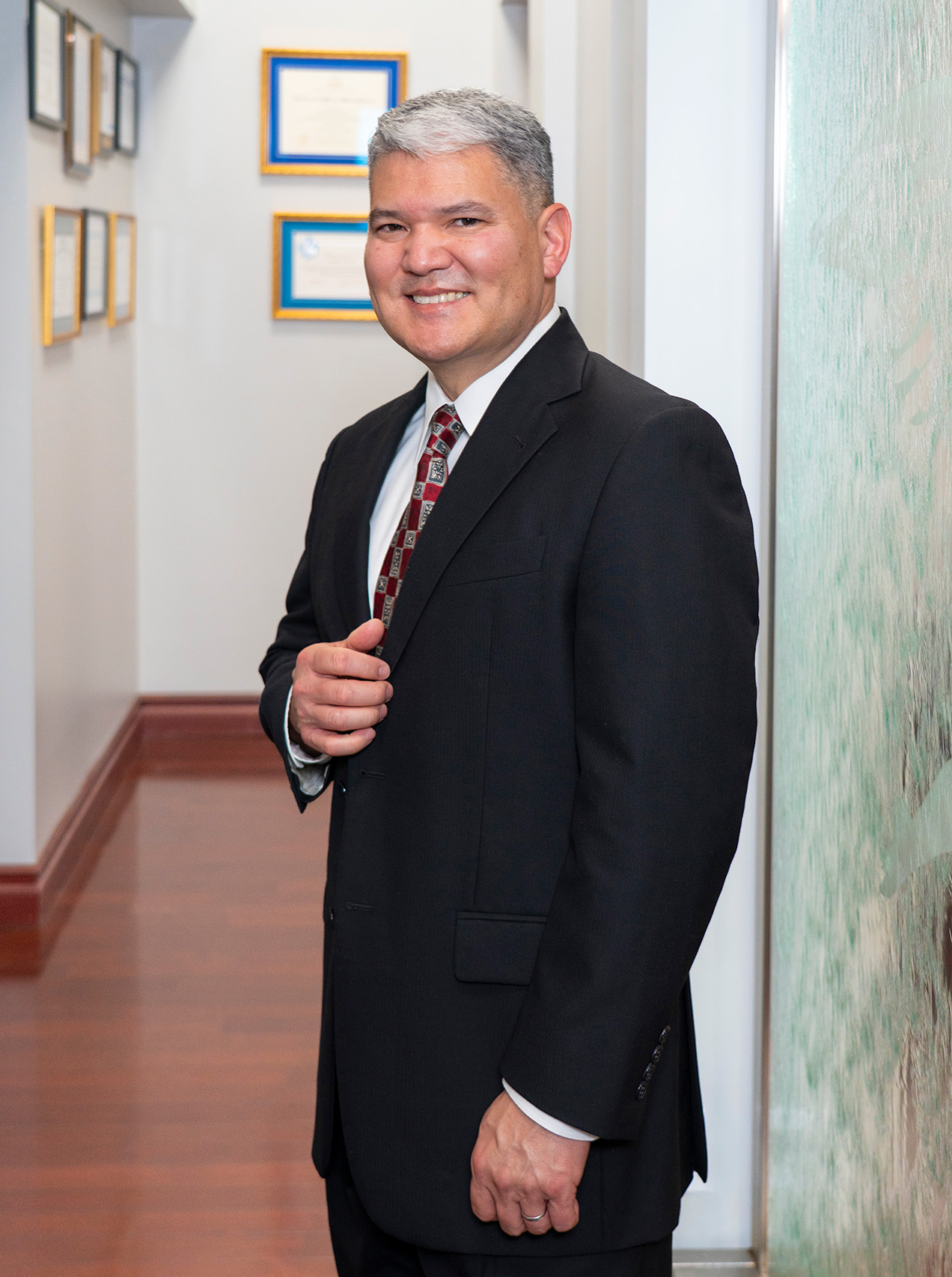 Dr. Chung in a suit in a hallway