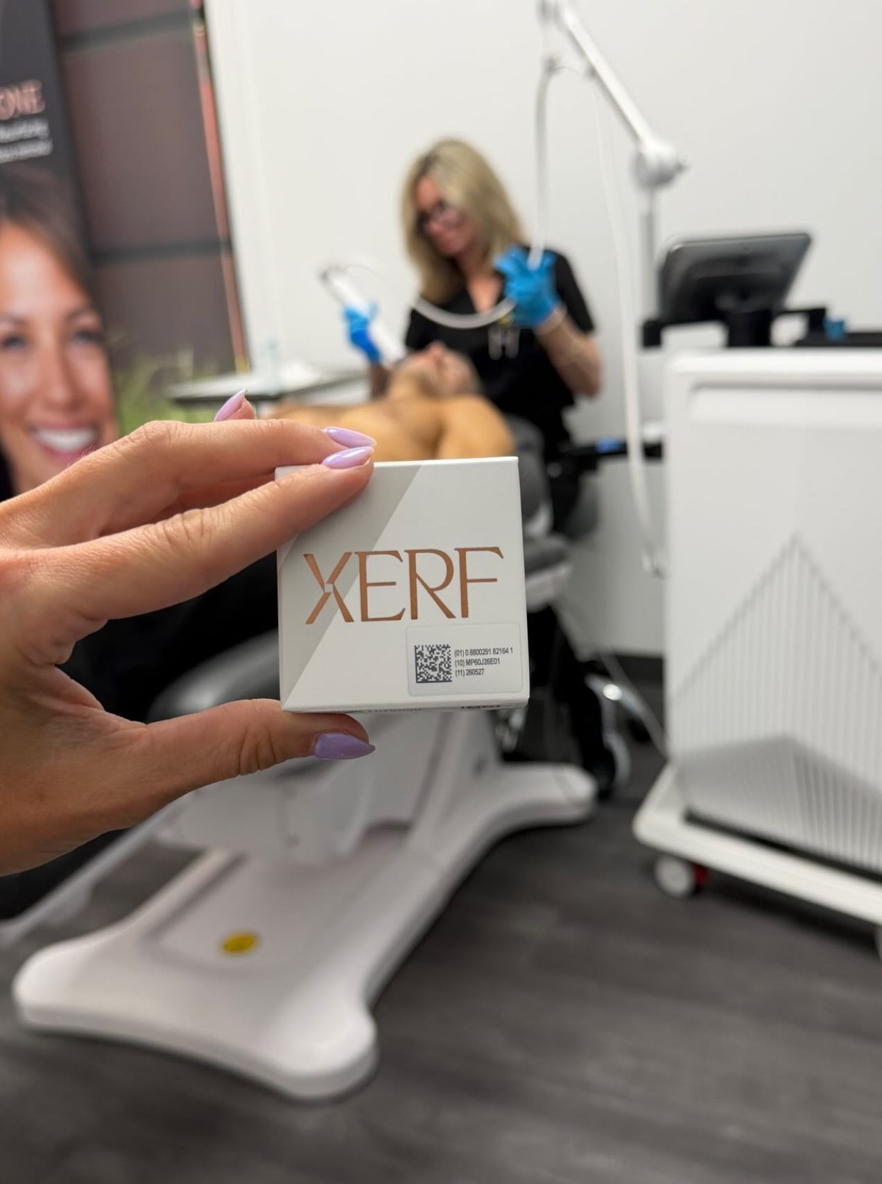 Dr. Debbie providing a XERF skin tightening RF treatment in the background while a XERF box is held in the foreground